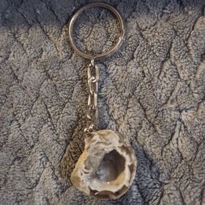 Oco agate geode fashioned into a keychain, showcasing a natural hollow interior